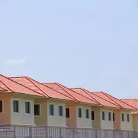 Fileira de casas iguais de telhado de telha vermelha, vistas de baixo contra o céu